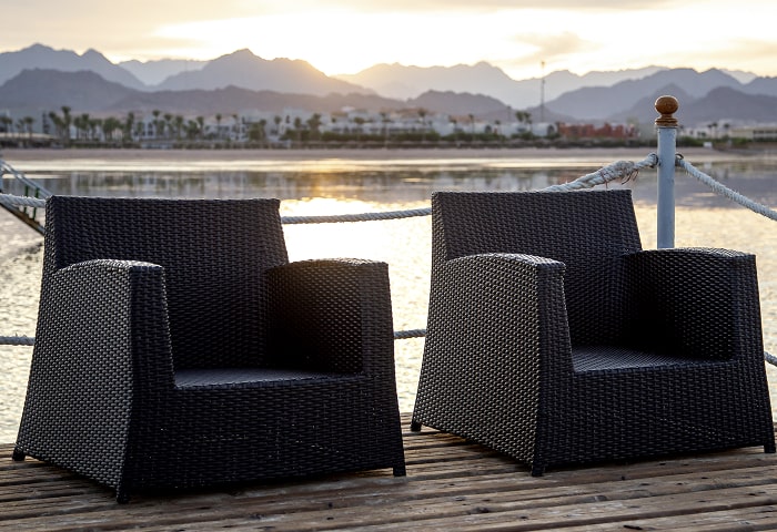 Two Empty Chairs Wooden Pier Overlooking Mountains Sunset Light